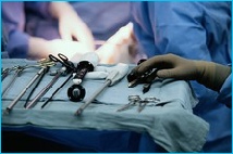 Theatre table showing long thin laparoscopic instruments used in laparoscopic colorectal cancer surgery