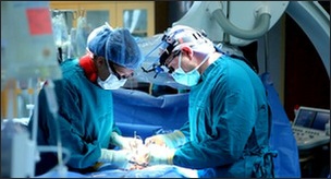 Two colorectal surgeons performing bowel cancer operation
