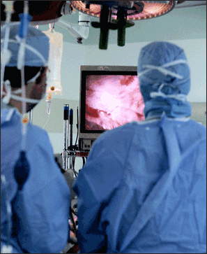 Colorectal surgeons performing laparoscopic colorectal surgery to remove a bowel cancer